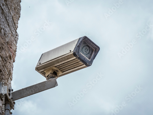 dirty cctv surveillance camera with smiley dust cover
