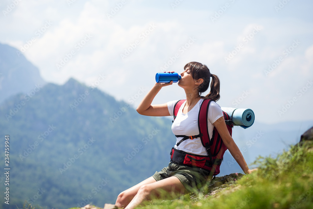 Hiker girl drinking water