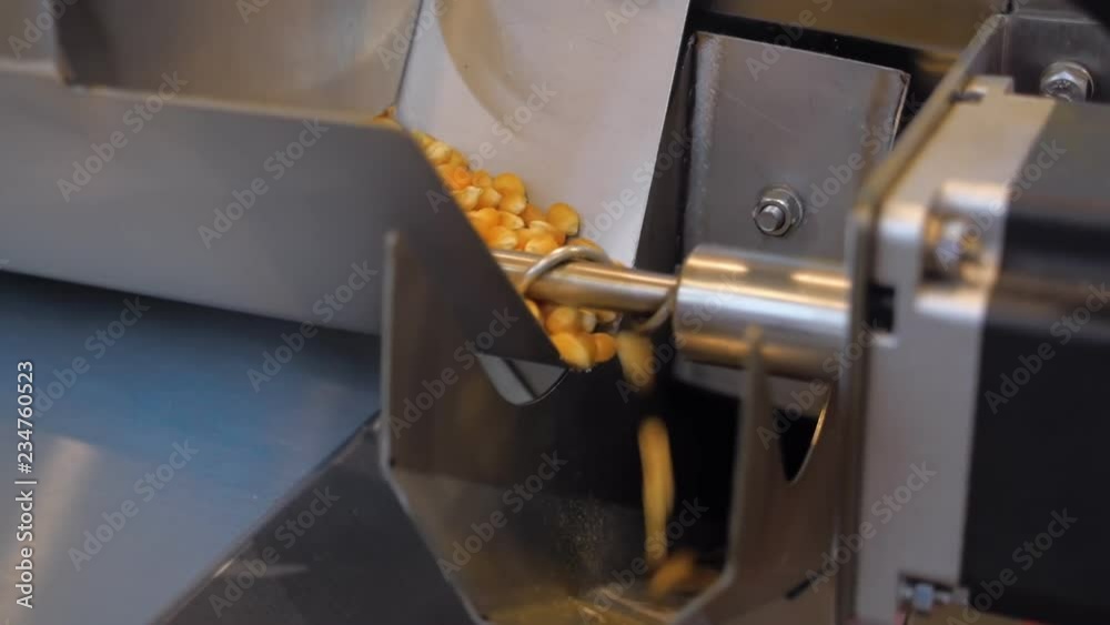 A popcorn machine produces large quantities of popcorn from corn grain