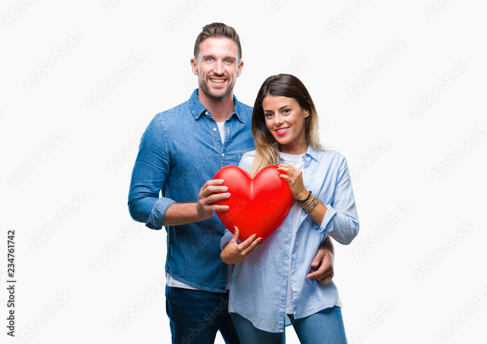 Young couple in love holding red heart over isolated background with a happy face standing and smiling with a confident smile showing teeth Young couple in love holding red heart over isolated background with a happy face standing and smiling with a confident smile showing teeth