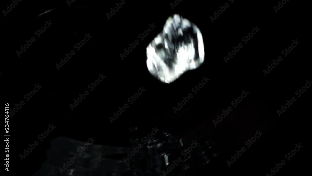 Falling of cubes of ice on a black background. Slow motion. Falling of cubes of ice on a black background. Slow motion.