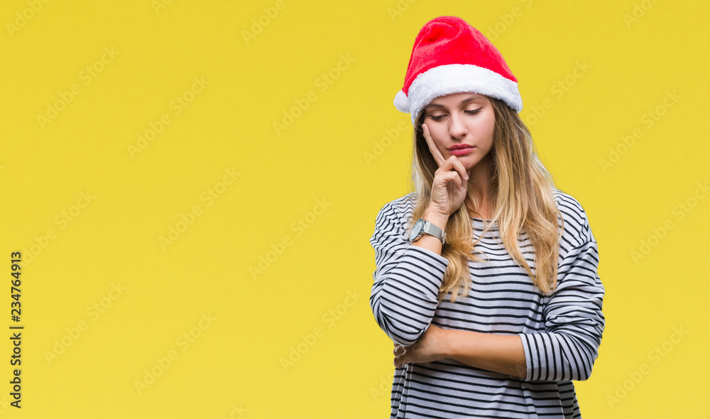 Young beautiful blonde woman wearing christmas hat over isolated background thinking looking tired and bored with depression problems with crossed arms. Young beautiful blonde woman wearing christmas hat over isolated background thinking looking tired and bored with depression problems with crossed arms.
