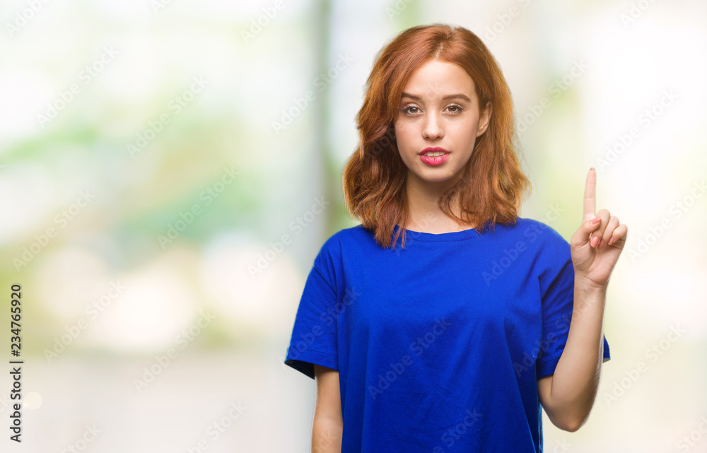 Young beautiful woman over isolated background showing and pointing up with finger number one while smiling confident and happy. Young beautiful woman over isolated background showing and pointing up with finger number one while smiling confident and happy.