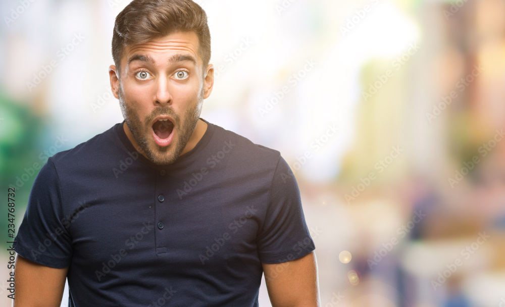 Young handsome man over isolated background afraid and shocked with surprise expression, fear and excited face.
