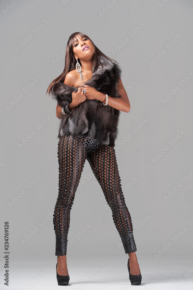 Young african-american woman wearing a fur jacket Young african-american woman wearing a fur jacket