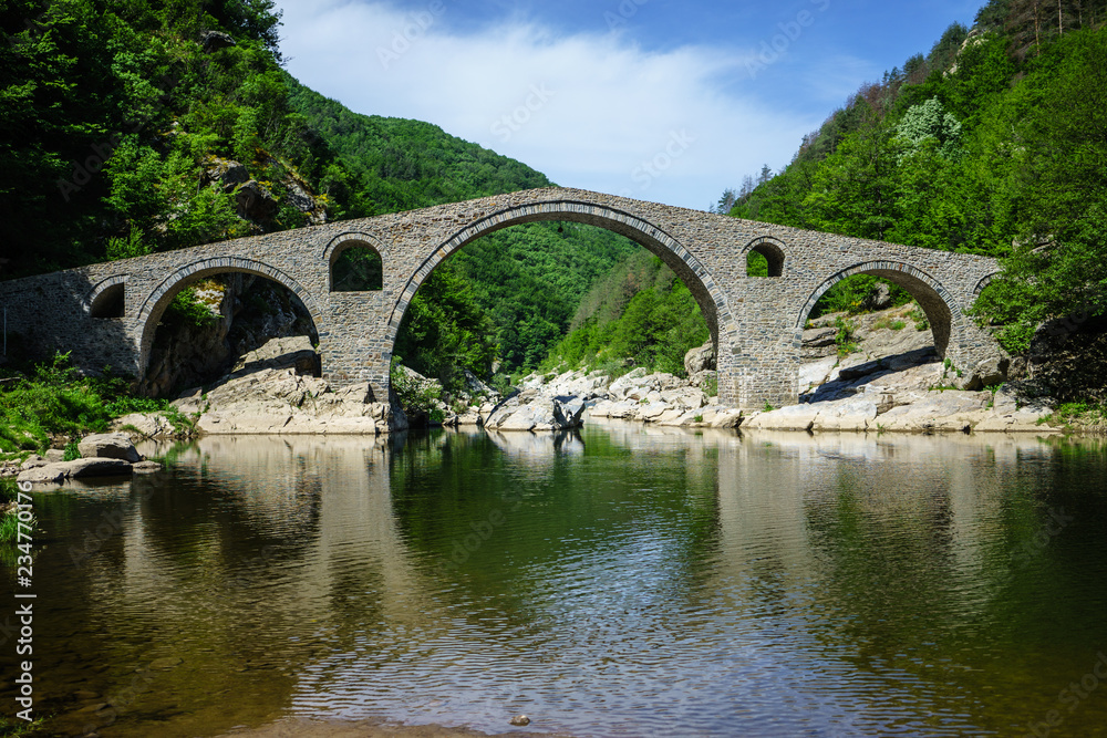 Devil's Bridge in Ardino Bulgaria top on Arda River, It is Ottoman Architecture Bridge in Rodopi Mountains Devil's Bridge in Ardino Bulgaria top on Arda River, It is Ottoman Architecture Bridge in Rodopi Mountains