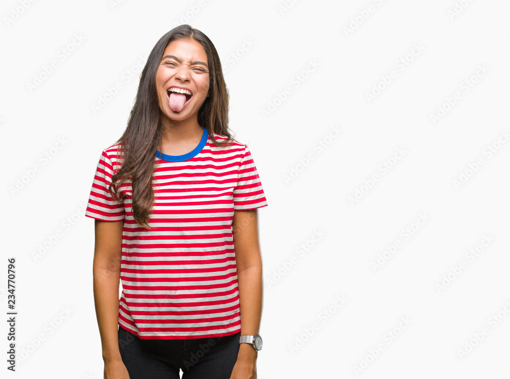 Obraz premium Young beautiful arab woman over isolated background sticking tongue out happy with funny expression. Emotion concept.