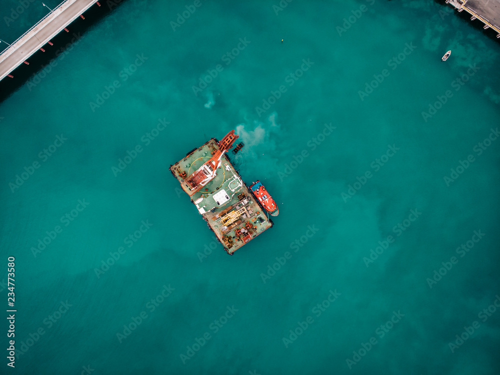 Offshore industrial platform or tower with crane or science sea research center, top or aerial view