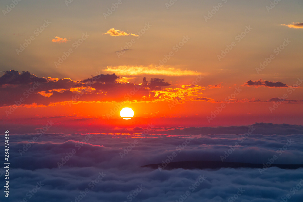 Sunset over clouds