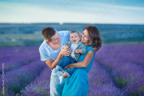 Canvas Print Family portrait mother father and baby son on lavender field having fun together