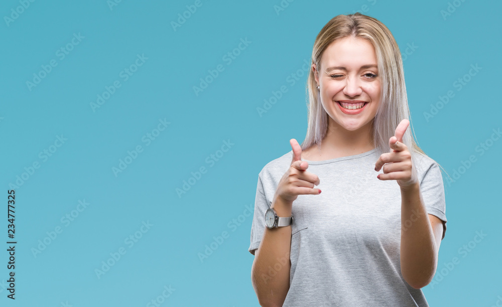 Young blonde woman over isolated background pointing fingers to camera with happy and funny face. Good energy and vibes. - obrazy, fototapety, plakaty 