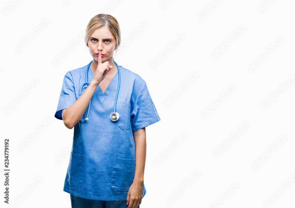 Young beautiful blonde doctor surgeon nurse woman over isolated background  asking to be quiet with finger on lips. Silence and secret concept. Stock  Photo | Adobe Stock