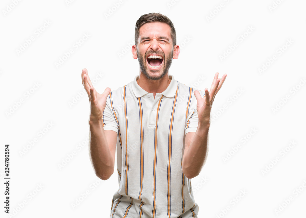 Naklejka premium Young handsome man over isolated background celebrating mad and crazy for success with arms raised and closed eyes screaming excited. Winner concept