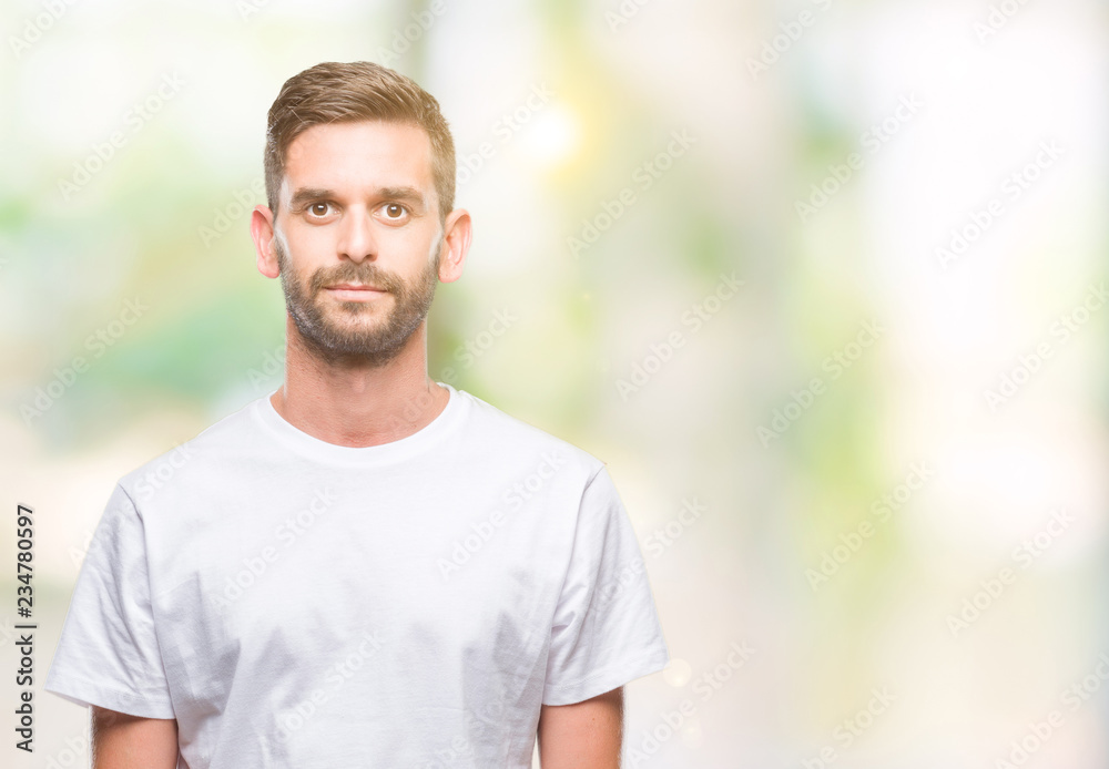 Young handsome man over isolated background with serious expression on face. Simple and natural looking at the camera. Young handsome man over isolated background with serious expression on face. Simple and natural looking at the camera.