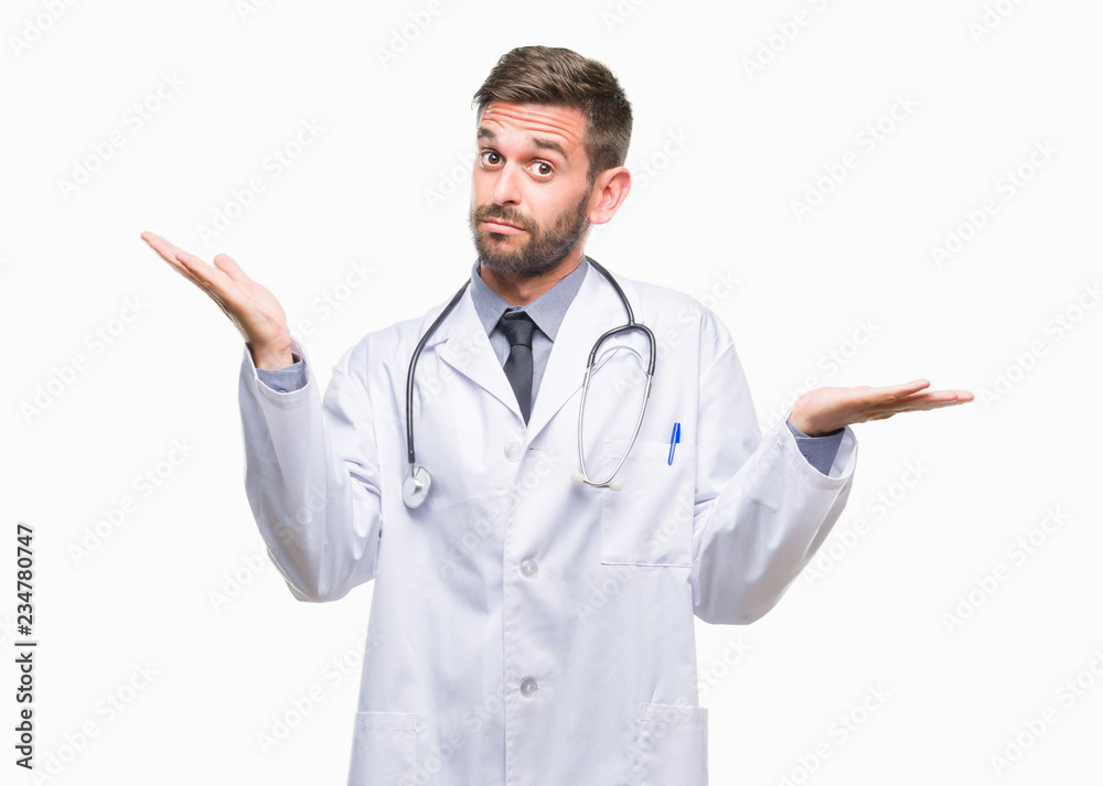 Young handsome doctor man over isolated background clueless and confused expression with arms and hands raised. Doubt concept. Young handsome doctor man over isolated background clueless and confused expression with arms and hands raised. Doubt concept.