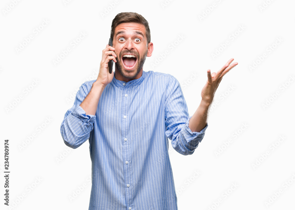 Young handsome man speaking on the phone over isolated background very happy and excited, winner expression celebrating victory screaming with big smile and raised hands Young handsome man speaking on the phone over isolated background very happy and excited, winner expression celebrating victory screaming with big smile and raised hands
