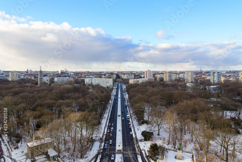 Photography Aerial panoramic view of cityscape of Berlin skyline and scenery of trees without leaves in winter season at Tiergarten park from above at Victory Column with background of dusk sunset sky