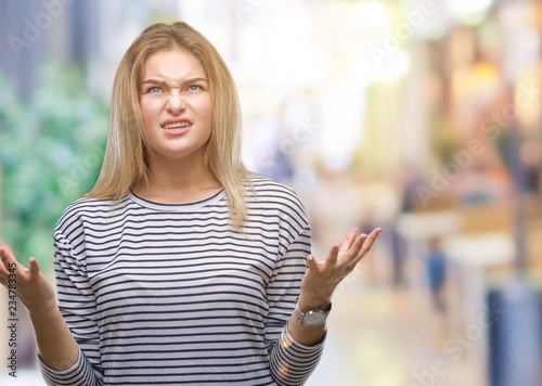 Young caucasian woman over isolated background crazy and mad shouting and yelling with aggressive expression and arms raised. Frustration concept.