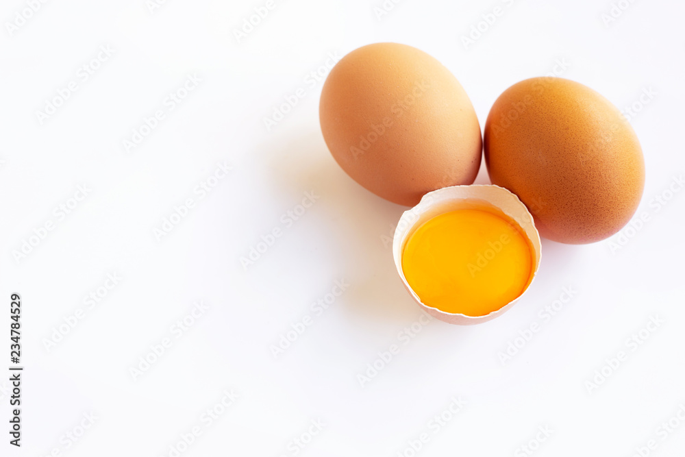 Chicken eggs with yolk on white background.