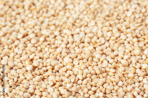 Raw white quinoa seeds as background, closeup