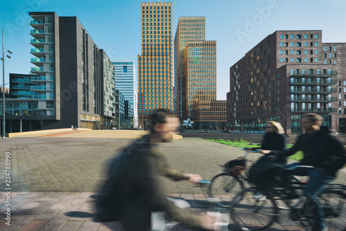 Office buildings in Amsterdam Zuid, Amsterdam, Netherlands. People bicycling in Amsterdam, Netherlands. photo