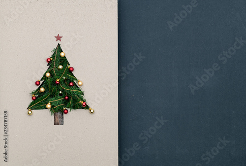 Text or logo empty copy space in vertical top view dark blackboard with natural eco decorated christmas tree pine in cardboard.Xmas winter holiday season party social media card background 