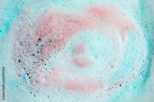 View of foam after dissolving color bath bomb in water, closeup
