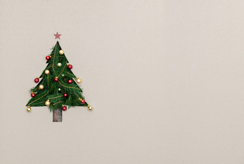 Text or logo empty copy space in vertical top view cardboard with natural eco decorated christmas tree pine.Xmas winter holiday season party social media card background 