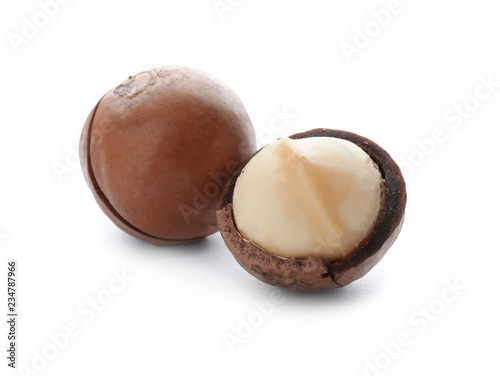Two organic Macadamia nuts on white background