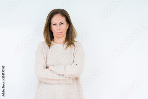 Beautiful middle age woman over isolated background skeptic and nervous, disapproving expression on face with crossed arms. Negative person. © Krakenimages.com