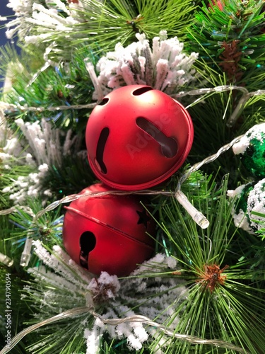 Red jingle bells on chrictmas tree photo