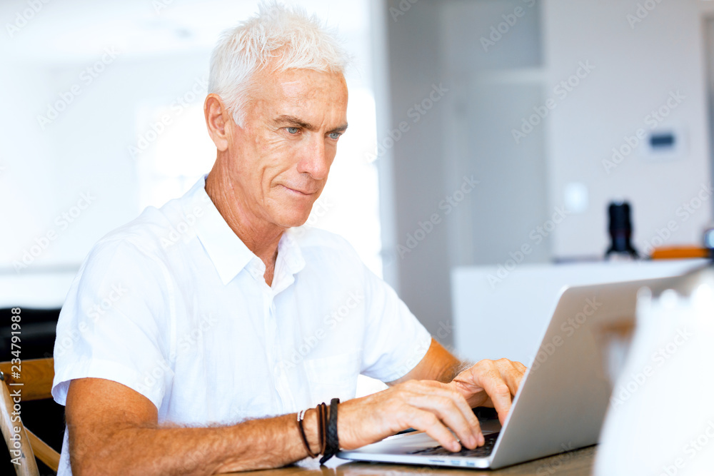 Man working on laptop at home