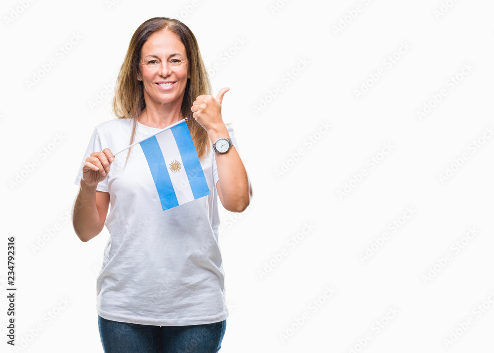 Middle age hispanic woman holding flag of Argentina over isolated background happy with big smile doing ok sign, thumb up with fingers, excellent sign Middle age hispanic woman holding flag of Argentina over isolated background happy with big smile doing ok sign, thumb up with fingers, excellent sign
