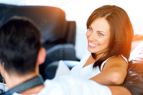 Woman talking to her husband sitting at home
