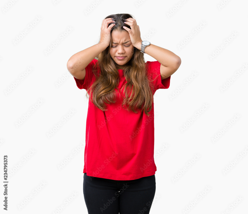 Young beautiful brunette woman wearing red t-shirt over isolated background suffering from headache desperate and stressed because pain and migraine. Hands on head. Young beautiful brunette woman wearing red t-shirt over isolated background suffering from headache desperate and stressed because pain and migraine. Hands on head.