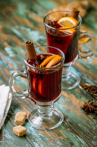 Mulled wine on old wooden background
