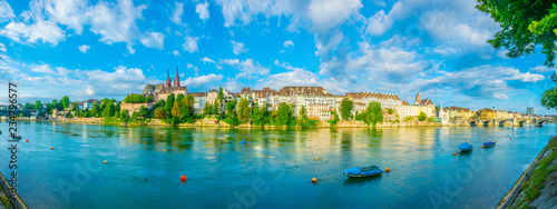 Riverside of Rhine in Basel dominated by majestic building of Munster church, Switzerland