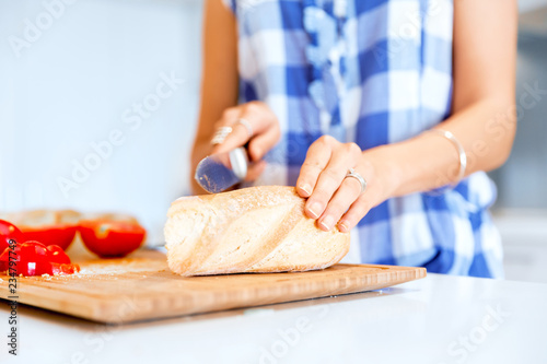 Woman hands cutting bread