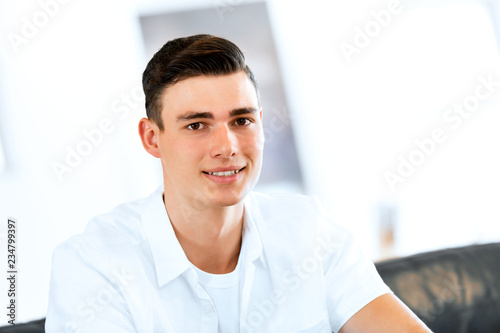 Portrait of a smart young man indoors photo