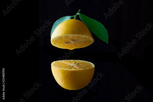 lemon fruit with leaf isolated on black background