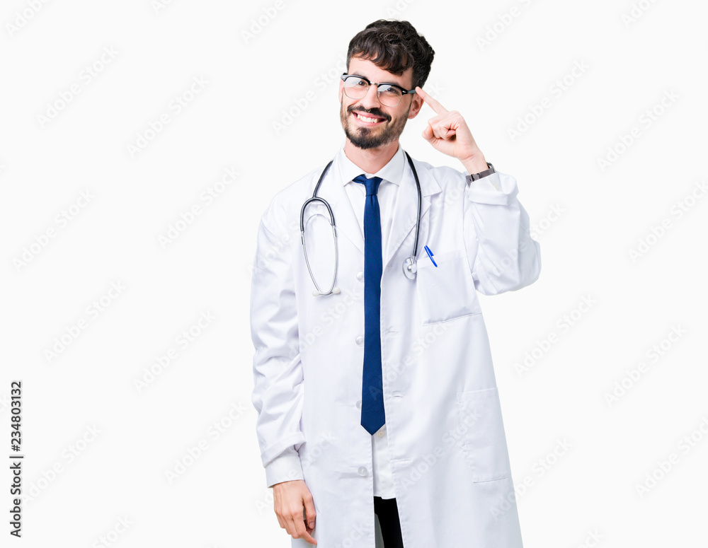Young doctor man wearing hospital coat over isolated background Smiling pointing to head with one finger, great idea or thought, good memory