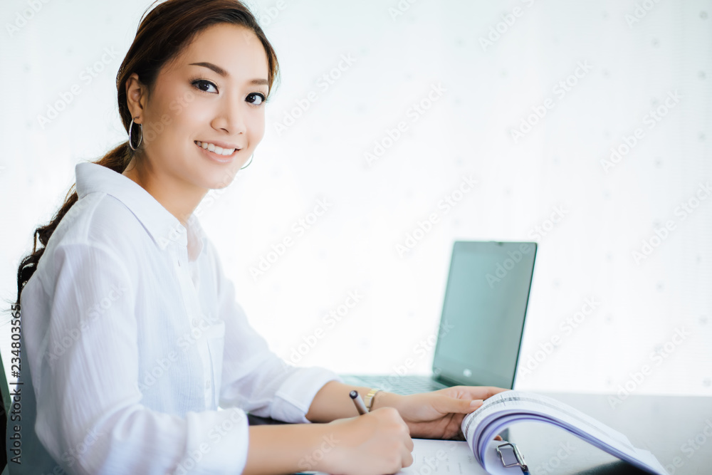 Asian business women using notebook and  smiling happy for working