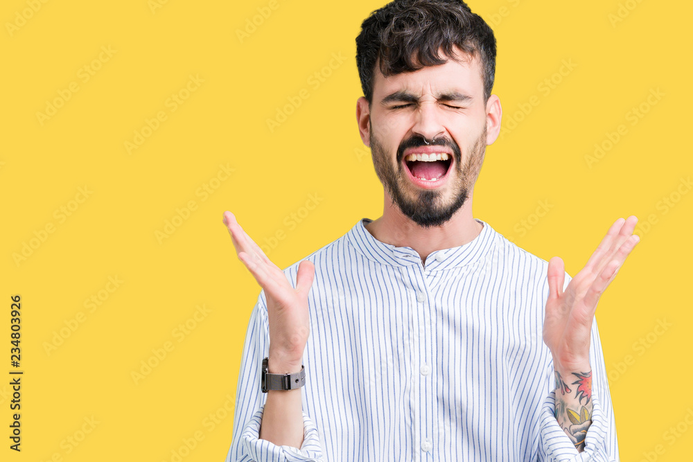 Young handsome business man over isolated background celebrating mad and crazy for success with arms raised and closed eyes screaming excited. Winner concept Young handsome business man over isolated background celebrating mad and crazy for success with arms raised and closed eyes screaming excited. Winner concept