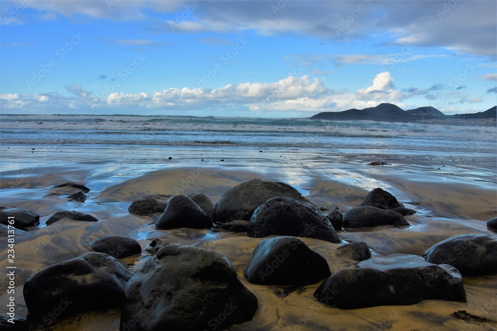 black volcanic stones on the shores of the atlantic ocean black volcanic stones on the shores of the atlantic ocean