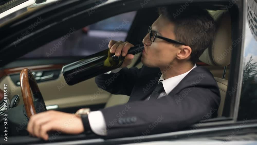 Businessman drinks alcohol before car driving, accident risk, irresponsibility Businessman drinks alcohol before car driving, accident risk, irresponsibility
