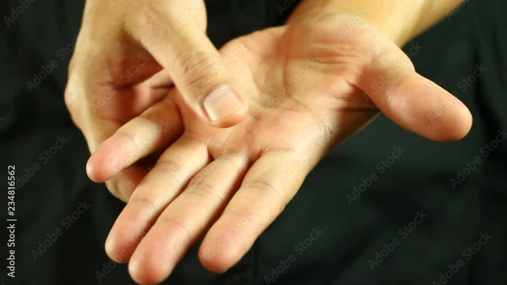 Man massaging his hand , in studio
Man massaging his hand , in studio