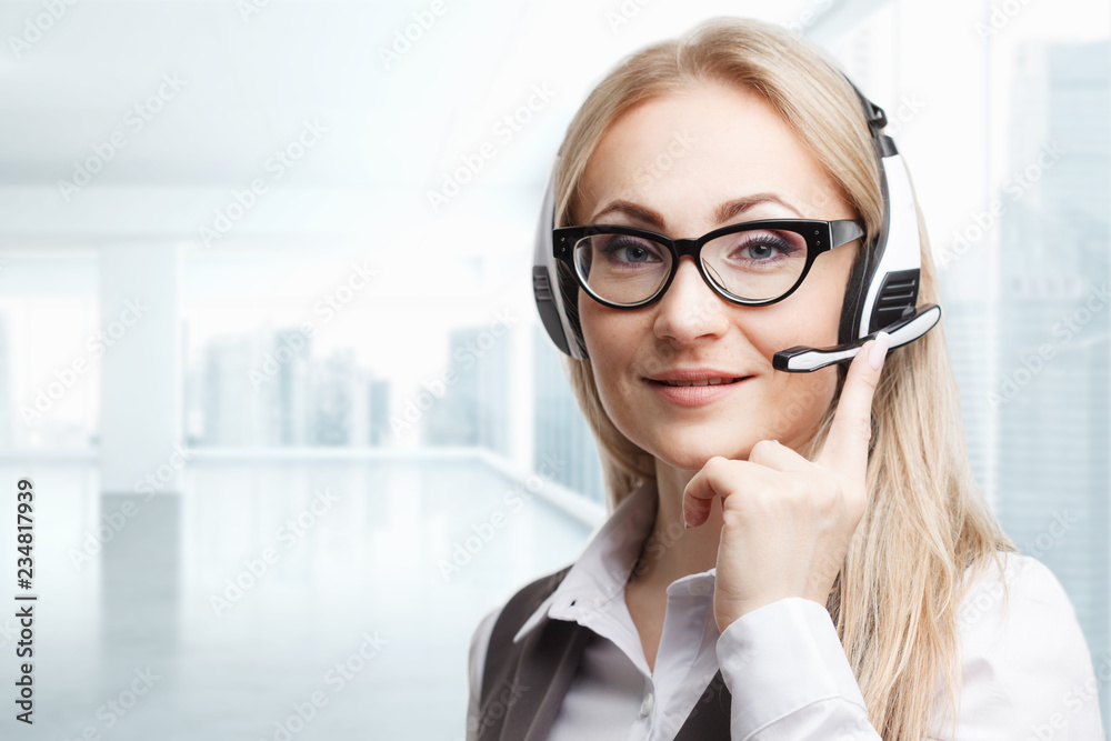 Three call center service operators at work. Portrait of smiling pretty female helpdesk employee with headset at workplace. Three call center service operators at work. Portrait of smiling pretty female helpdesk employee with headset at workplace.