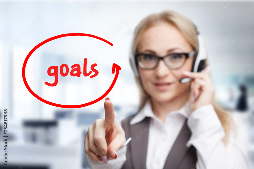 Technology, internet, business and marketing. Young business woman writing word: goals Technology, internet, business and marketing. Young business woman writing word: goals