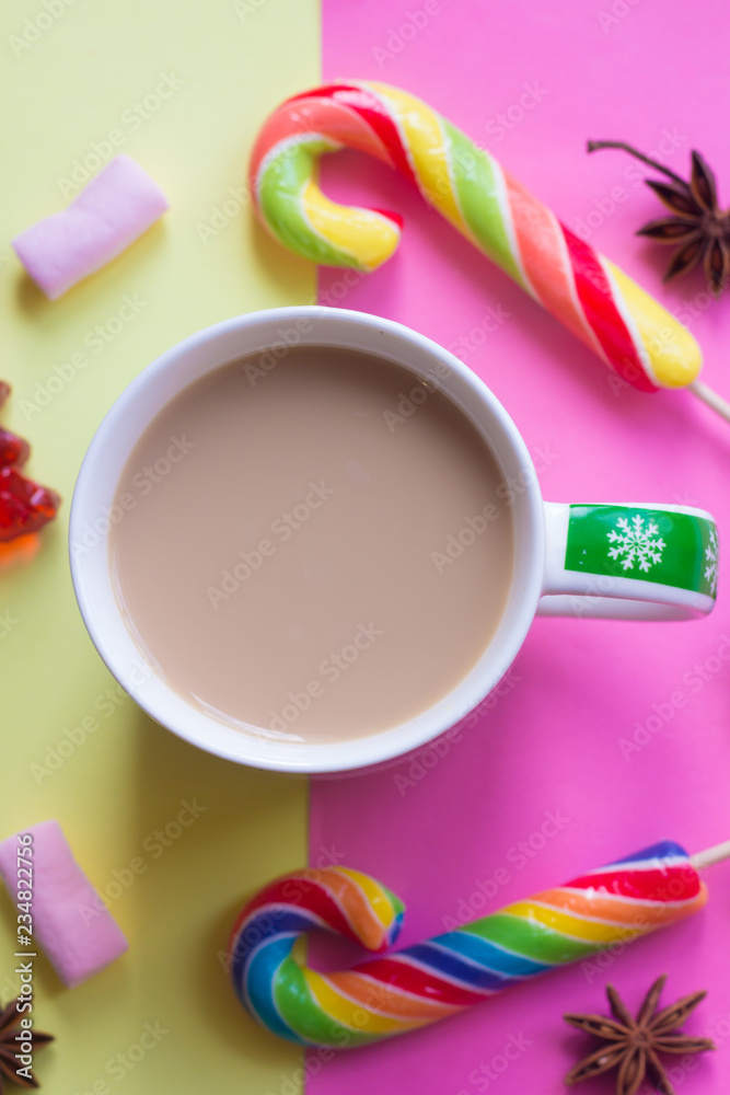 Coffee with milk and lollipop. New Year's coffee. Sweet and drink. Festive mood.