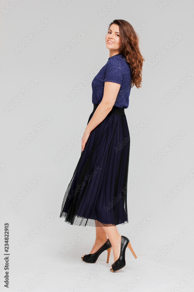 Young charming brunette woman with curly hair in evening elegant Young charming brunette woman with curly hair in evening elegant